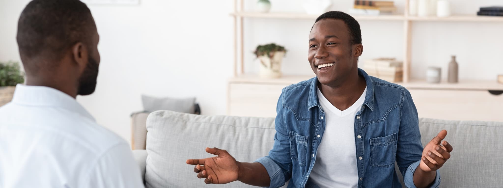 Man smiling and speaking openly during a therapy session — the openness and relief that comes with good psychiatric care