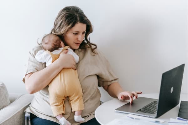 Young mother holding her newborn — perinatal and postpartum mental health support at Minnesota Mental Health Clinics