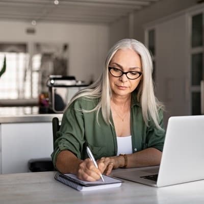 Confident midlife woman at her computer for a telehealth mental health appointment