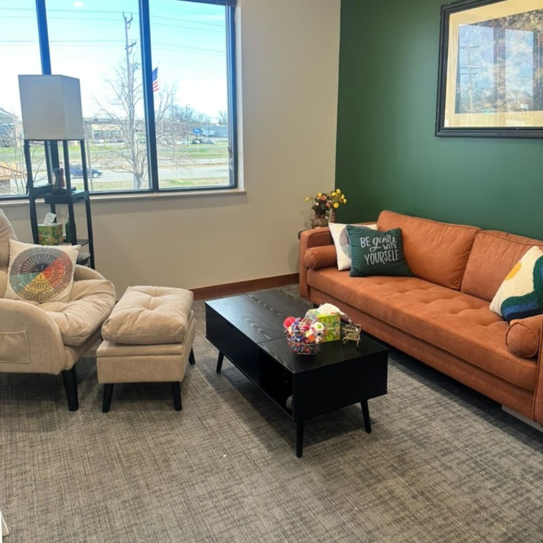 Welcoming therapy office at Minnesota Mental Health Clinics featuring a warm orange sofa and comfortable seating